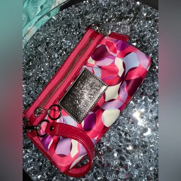 Coach Poppy Wristlet featuring a pink and purple geometric pattern. - Picture 2 of 9